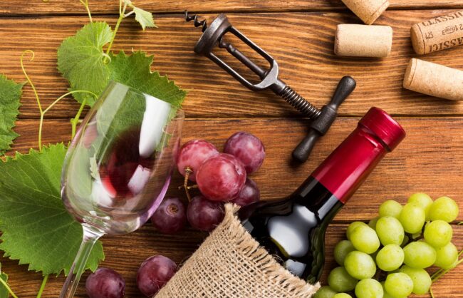 wine-chianti-FP Closeup of bottle of Chianti with red and white grapes.