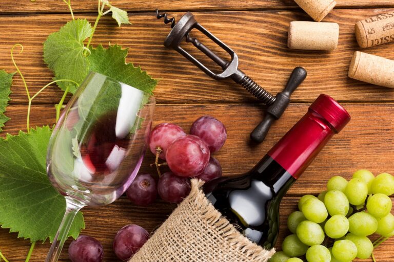 Closeup of bottle of Chianti with red and white grapes.