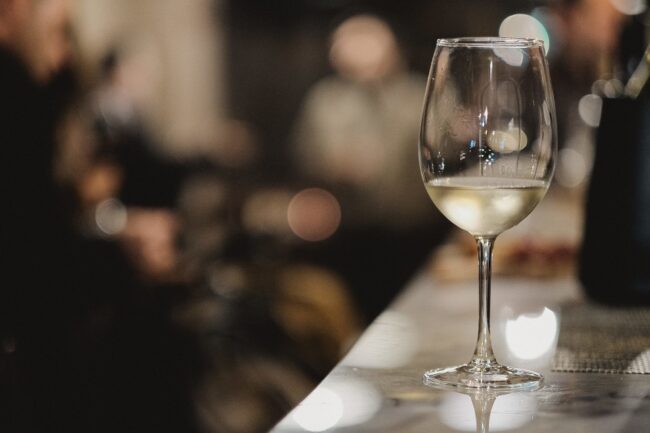 Shallow focus shot of a glass of white wine Glass of white wine illustrates blog "Is Pinot Grigio a Dry Wine? "
