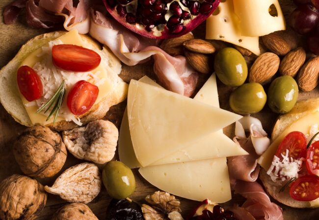 charcuterie-FP Closeup of cheese and different types of meat illustrates blog "What Are the Best Wines to Pair With Charcuterie?"