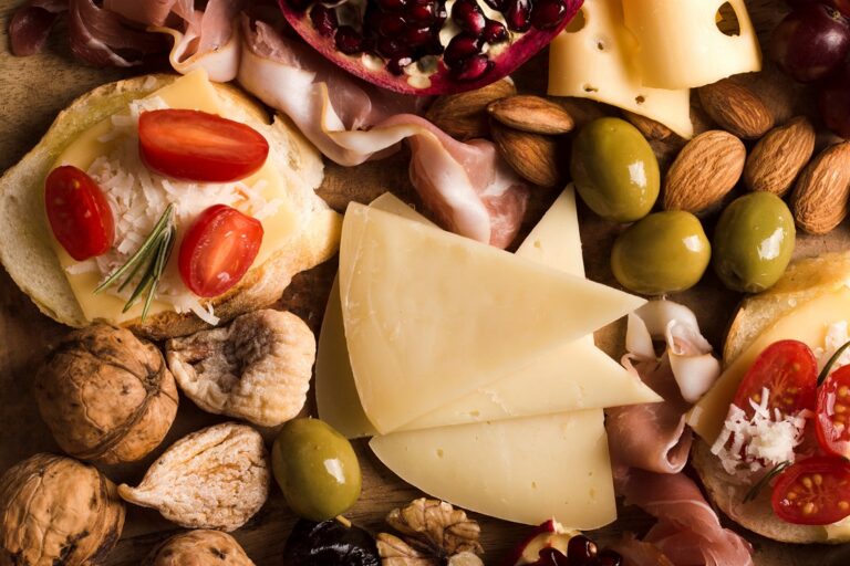 Closeup of cheese and different types of meat illustrates blog "What Are the Best Wines to Pair With Charcuterie?"