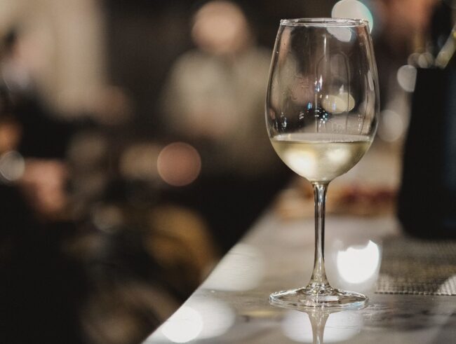 A shallow focus shot of a glass of white wine isolated