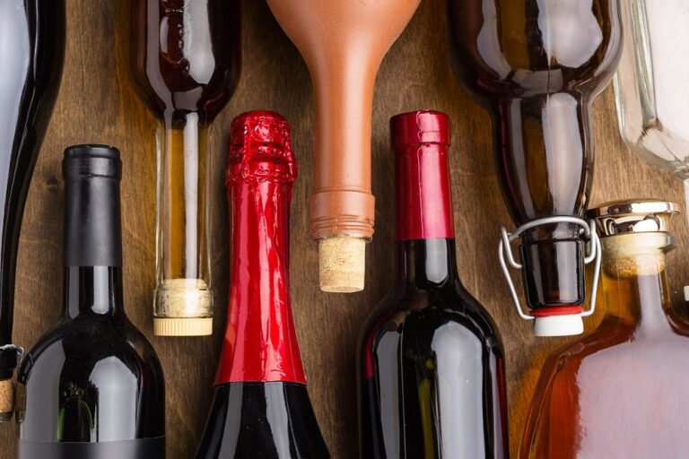 Bottles of wine seen from above illustrate blog "Does Wine Need To Be Refrigerated After Opening?"