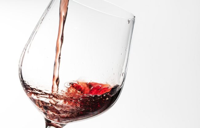 Red wine pouring into a wine glass Closeup of Zinfandel being poured into a wine glass.