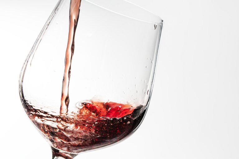 Closeup of Zinfandel being poured into a wine glass.